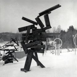 David Smith overseeing the placement of <em>Five Units Equal </em>(1956) onto a base in his workshop at Bolton Landing, 1956